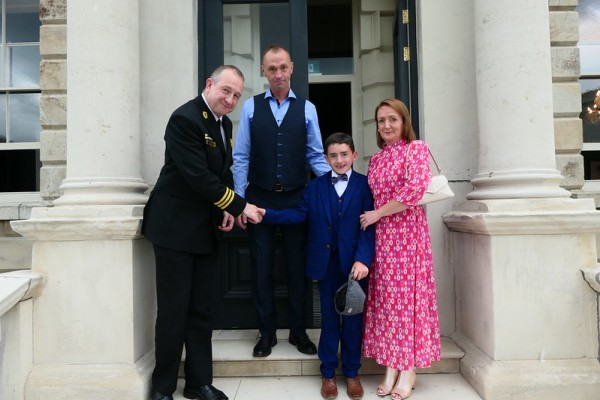 Aaron O'Shea on the steps of Leinster House with his mum and dad