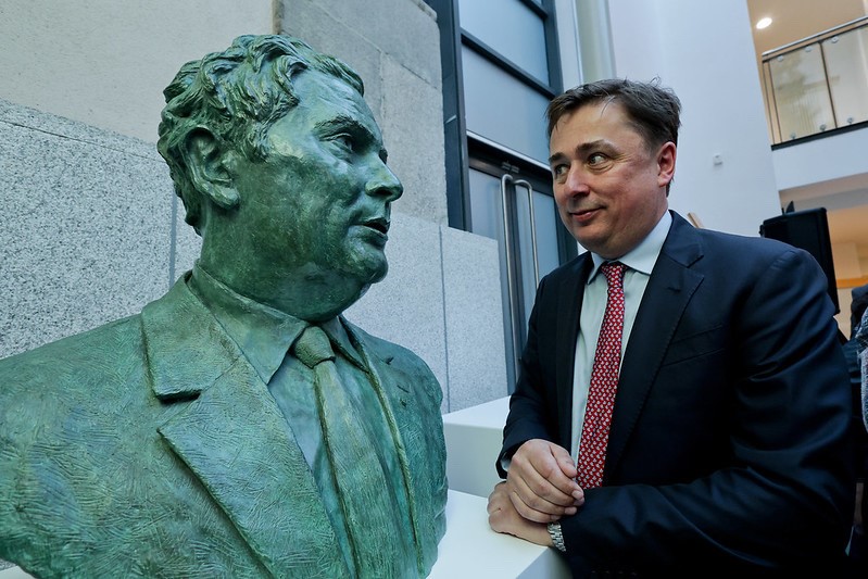 A bronze mid-torso length bust of John Hume unveiled in Leinster House in March 2023. John Hume's son, a faint smile on his face, is pictured looking at the bust in a manner that looks like father and son are looking at each other