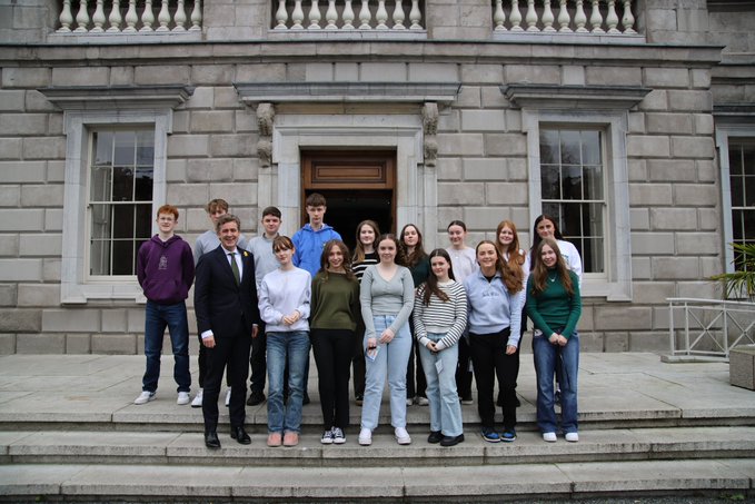 A group of transition year students attending Leinster House for work experience have a group photo on the plinth
