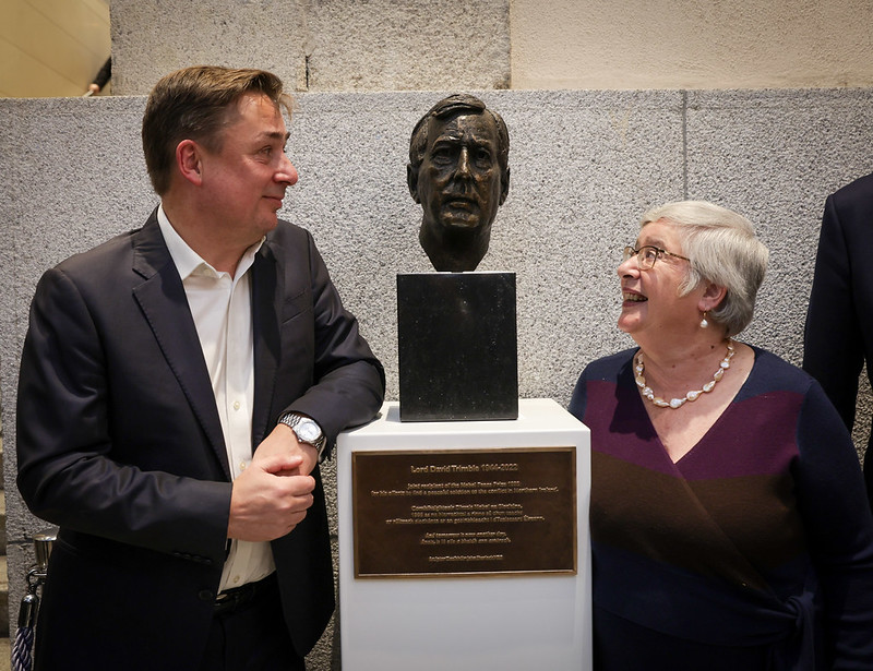 John Hume Jr. and Lady Daphne Trimble beside a bust of Lord David Trimble in Leinster House