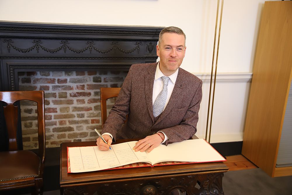 Senator Malachai O'Hara signs the roll before taking his seat in Seanad Éireann